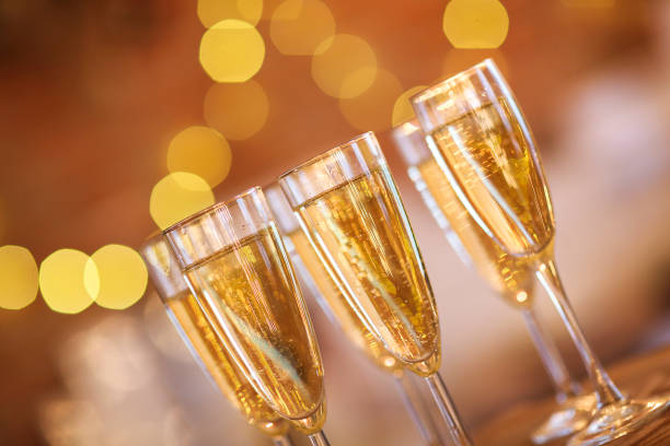 istock Champagne glasses on golden background 856672082
