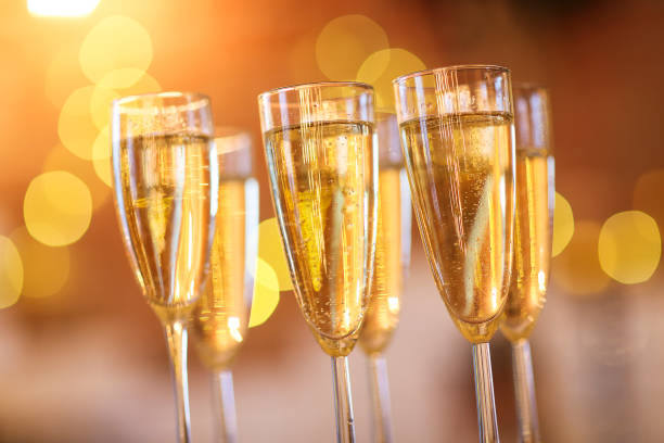 istock Champagne glasses on golden background 856672198