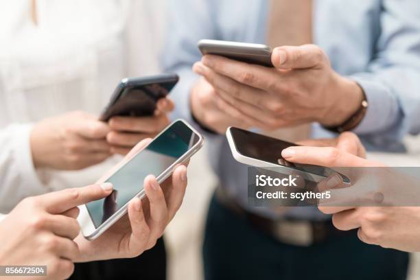 Friends Having Fun Together With Smartphones Stock Photo - Download Image Now - Smart Phone, Mobile Phone, Telephone