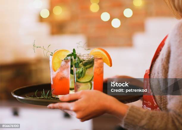 Young Pretty Woman With Red And Green Cocktails On Tray Stock Photo - Download Image Now