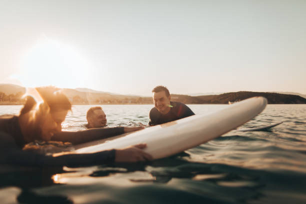 istock Friends surfing in the ocean 856679354