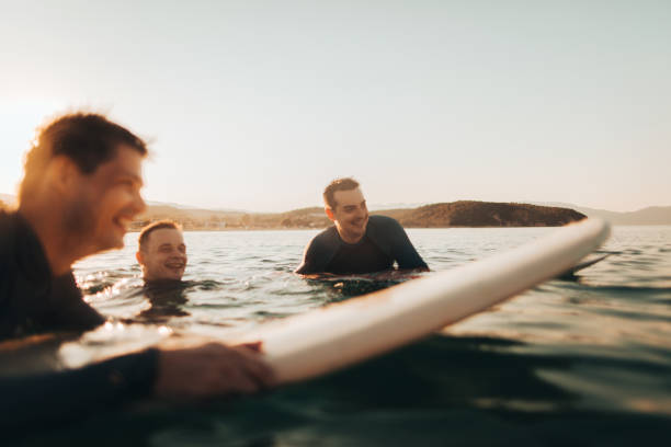 istock Friends surfing in the ocean 856679454