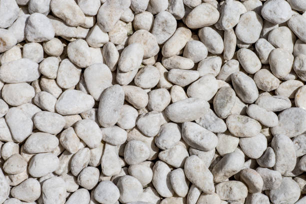 istock Naturally polished white rock pebbles background. 856689294