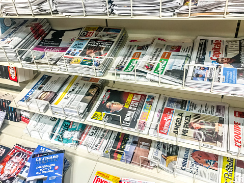 Brussels, Belgium - September 23, 2017: Variety of newspapers displayed in newsstand in Brussels airport