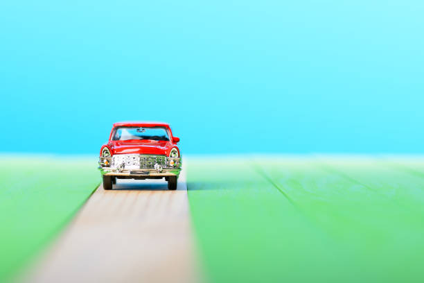 istock Red vintage car model on wooden boards 856696410