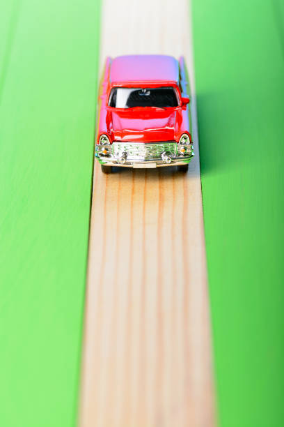 istock Red vintage car model on wooden boards 856697104