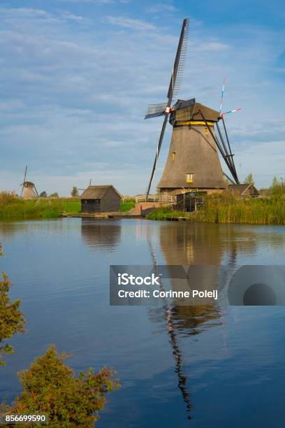 Windmill In Dutch Water Landscape Kinderdijk The Netherlands Against Cloudy Sky Stock Photo - Download Image Now