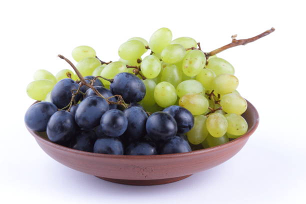 istock Green and blue grapes in a clay plate on a white background 856702688