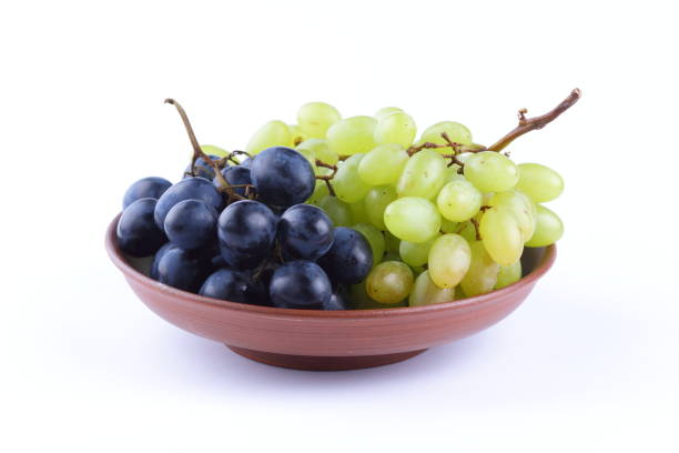 istock Green and blue grapes in a clay plate on a white background 856702742