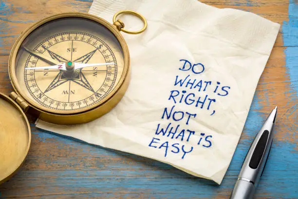 Do what is right, not what is easy  advice or reminder - handwriting on a napkin with an antique brass compass