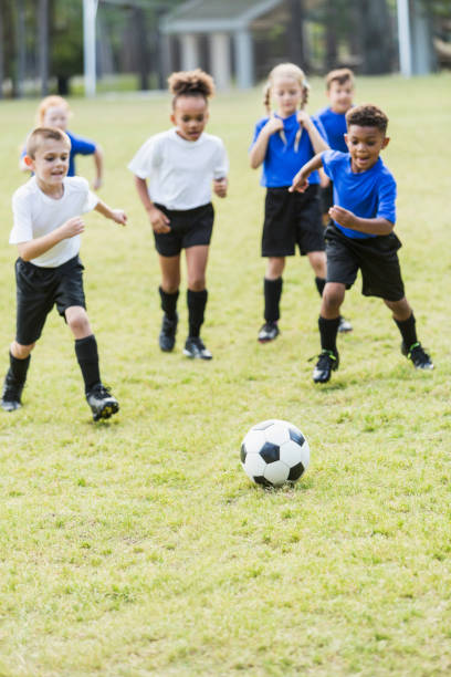 istock Children playing soccer, chasing the ball 856714560