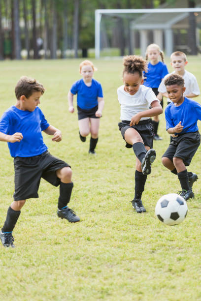 istock Children playing soccer, competing for ball 856714570