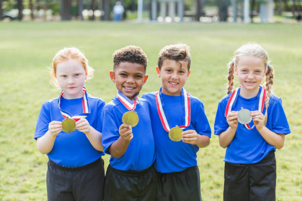 istock Multi-ethnic children on winning team, with medals 856714836