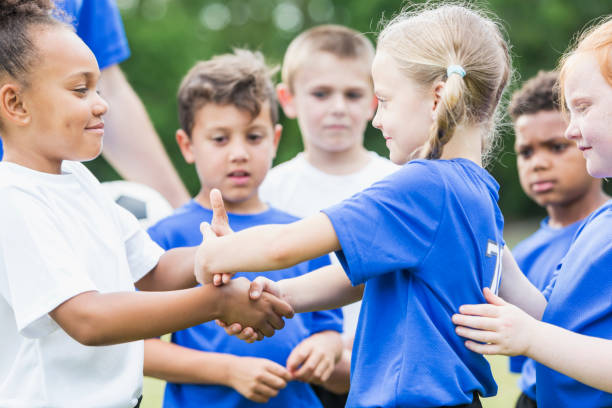 istock Children's soccer team, girls shaking hands 856717526