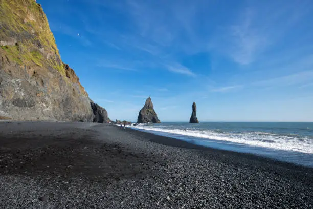 Coast of Reynisdrangar in iceland on a day with bright blue sky. Also known as blackbeach.