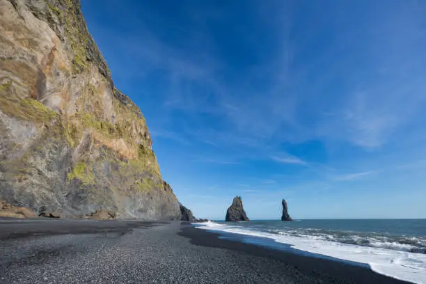 Coast of Reynisdrangar in iceland on a day with bright blue sky. Also known as blackbeach.