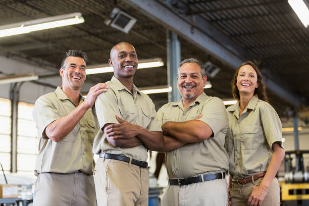 istock Four trucking company workers in garage 856721708