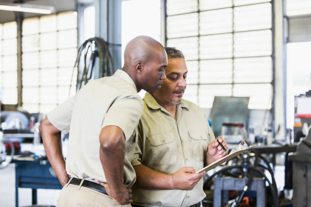 istock Workers in truck repair shop 856726524