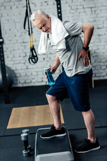 istock senior sportsman with back pain 856732964