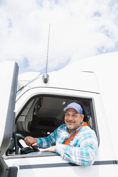 istock Hispanic man driving a semi-truck 856733076