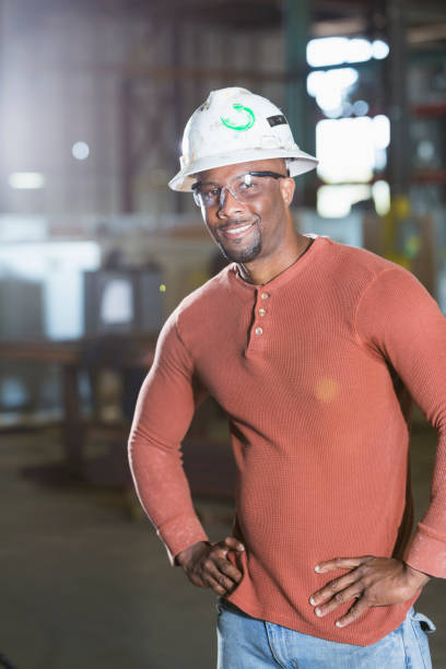 istock Black man in warehouse wearing hardhat 856733684