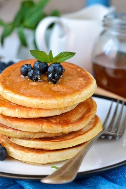 istock Homemade vanilla punkcakes with syrup and blueberries for breakfast. Good morning! 856740310
