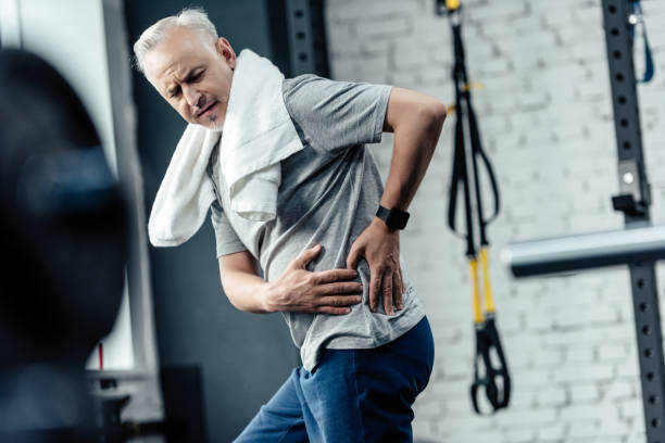 istock senior sportsman with back pain 856741142