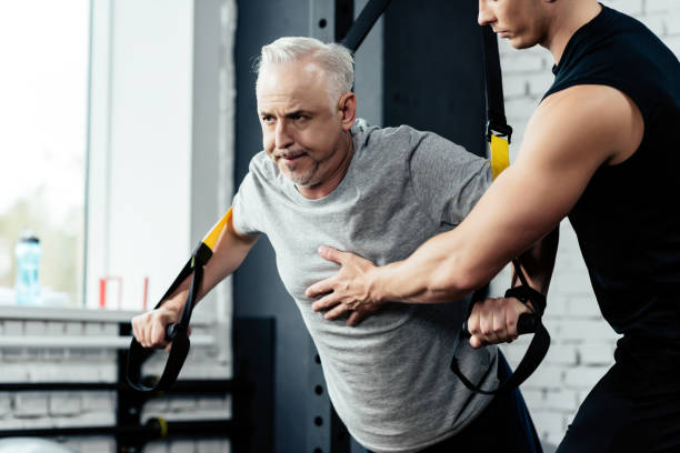 istock senior sportsman training with trx 856744318