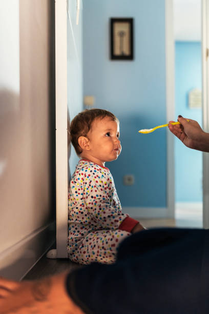 istock Little boy eating puree with a spoon. 856747552
