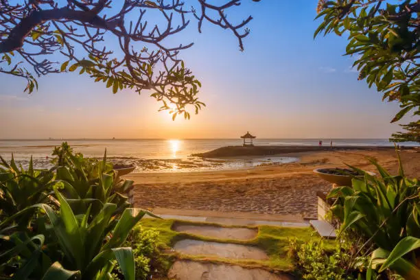 Beautiful sunrise on a beach in Bali Indonesia with colourful sky as background