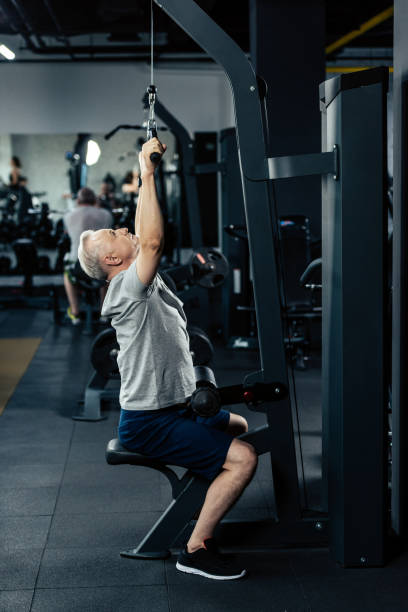 istock senior sportsman lifting weights 856756526