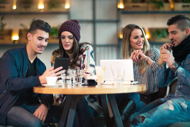 istock Group of young people sitting in a coffee shop having fun 856756752