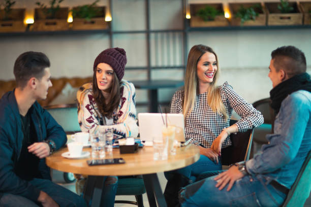 istock Group of young people sitting in a coffee shop having fun 856756756