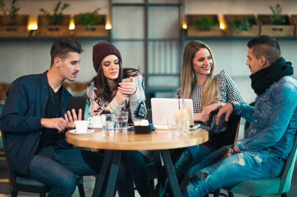 istock Group of young people sitting in a coffee shop having fun 856756766