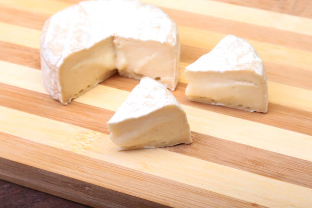 istock Cheese with white mold. Camembert or brie type on wood table. Healthy breakfast. 856760654