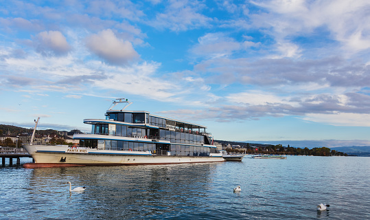 Zurich, Switzerland - 1 October, 2017: MS Panta Rhei at a pier on Lake Zurich. MS Panta Rhei is a ship of the Lake Zurich Navigation Company (German: Zurichsee-Schifffahrtsgesellschaft, commonly abbreviated to ZSG) is a public Swiss company operating passenger ships and boats on Lake Zurich.