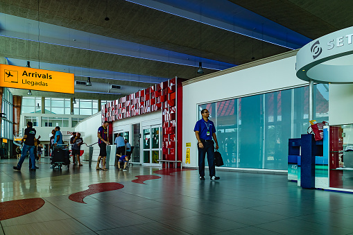 Aruba Airport, Aruba - September 11, 2017: The arrivals area of the small airport on the Caribbean Island of Aruba. THe area seen in the image is just outside the Baggage and Customs Section.  Some passengers who have just arrived can also be seen in the image. Horizontal format.