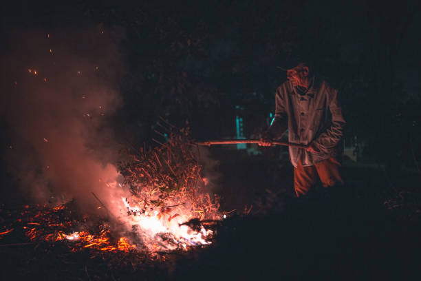 istock Old man burning a fire in the night 856780958