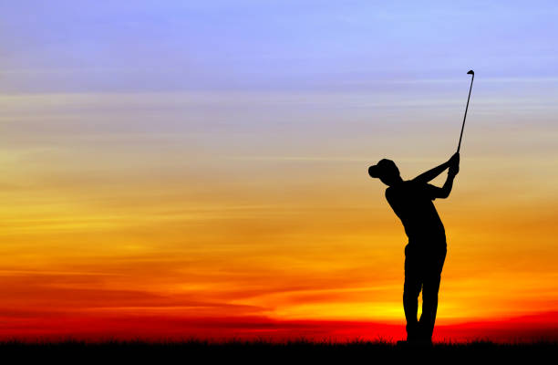 istock silhouette golfer playing golf during beautiful sunset 856783250