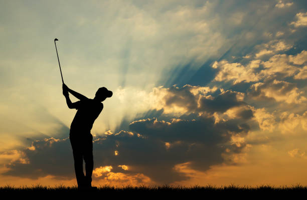 istock silhouette golfer playing golf during beautiful sunset 856783260