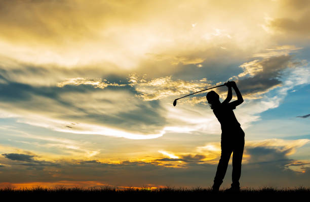 istock silhouette golfer playing golf during beautiful sunset 856783268