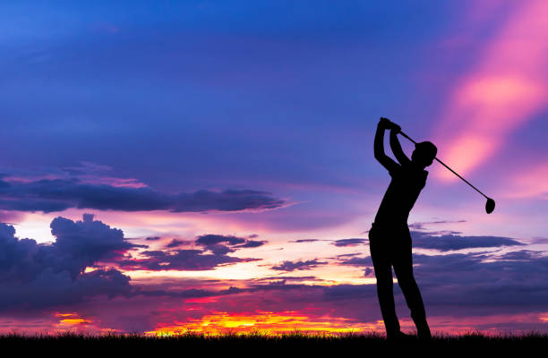istock silhouette golfer playing golf during beautiful sunset 856783286
