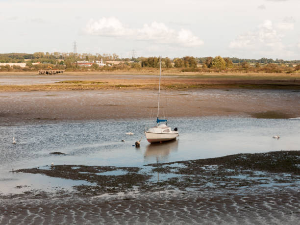 istock single white boat with mast parked in estuary river stream outside landscape 856783328