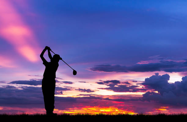 istock silhouette golfer playing golf during beautiful sunset 856783408