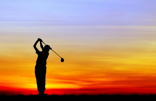 istock silhouette golfer playing golf during beautiful sunset 856783412