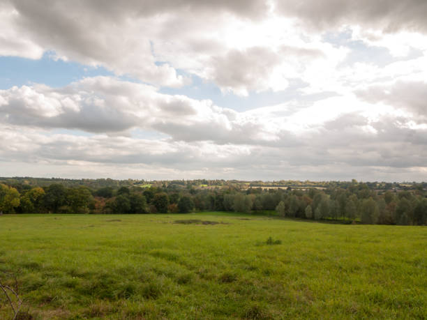 istock stormy clouds overcast autumn day sunlight over open field with trees 856783474