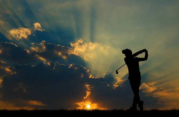 silhouette golfer playing golf during beautiful sunset