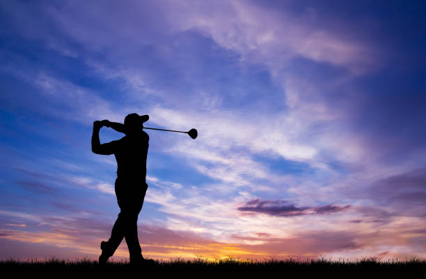 istock silhouette golfer playing golf during beautiful sunset 856783498