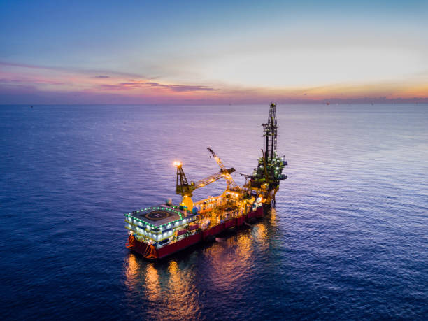 Aerial View of Tender Drilling Oil Rig (Barge Oil Rig) Aerial View of Tender Drilling Oil Rig (Barge Oil Rig) in The Middle of The Ocean at Surise Time oil derrick crane crane exploration stock pictures, royalty-free photos & images