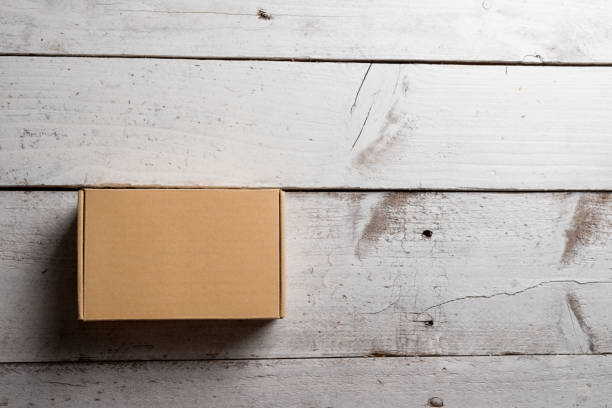 istock Cardboard box on a wooden background 856790784